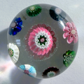 Antique Clichy concentric on clear ground. 8 pastry mold complex canes surrounding a very large lovely pink center pastry mold complex cane. a tall dome on this mini. 1.65"