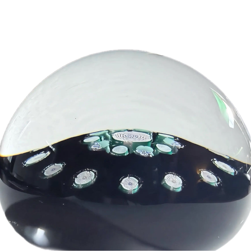 John Deacons medium cionceantric paperweight with a clichy rose style garland, a clichy rose style&nbsp; and flower cane concentric ring of 10 surrounding a clichy rose style center cane atop an opaque black ground .18 total clichy style roses.&nbsp; JMD 2008 with heart signature cane on base. 2.9"