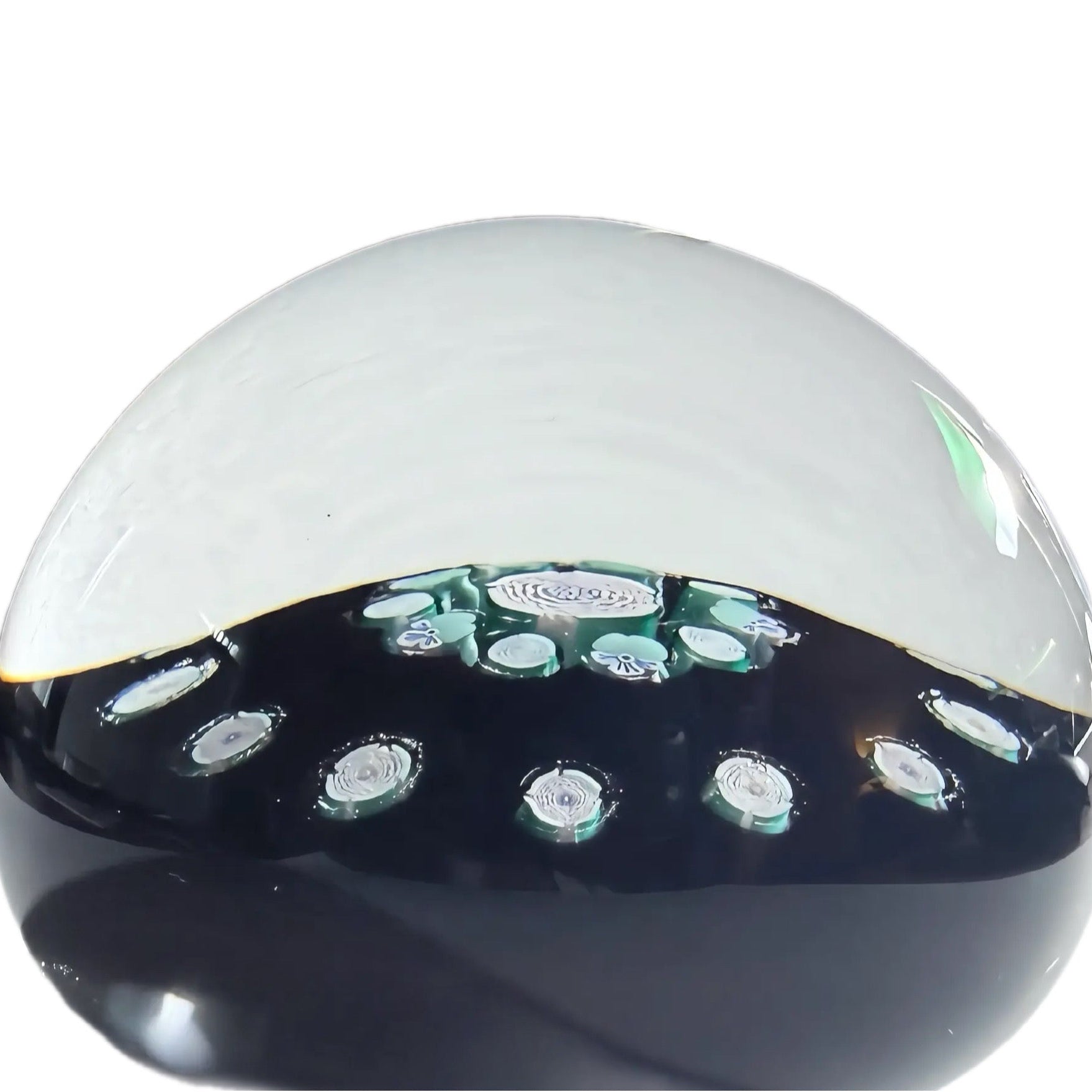 John Deacons medium cionceantric paperweight with a clichy rose style garland, a clichy rose style&nbsp; and flower cane concentric ring of 10 surrounding a clichy rose style center cane atop an opaque black ground .18 total clichy style roses.&nbsp; JMD 2008 with heart signature cane on base. 2.9"