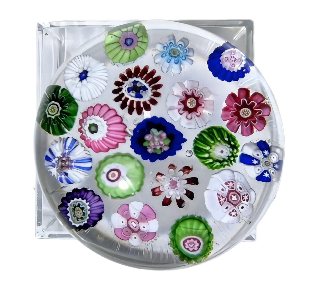 Antique Clichy with the familiar version of 19 striking and vibrant complex canes arranged in a concentric pattern. The wonderfully clear glass, in contrast with the still vibrant colors of the canes, is remarkable after nearly 200 years. It really pops. A wonderful variety and some near-perfect bullseye canes and pastry molds seen here. There's a basal ring on the base that's appropriate for the period. Other than that, the paperweight is near perfect. Acquired from a collector in Switzerland in August 202