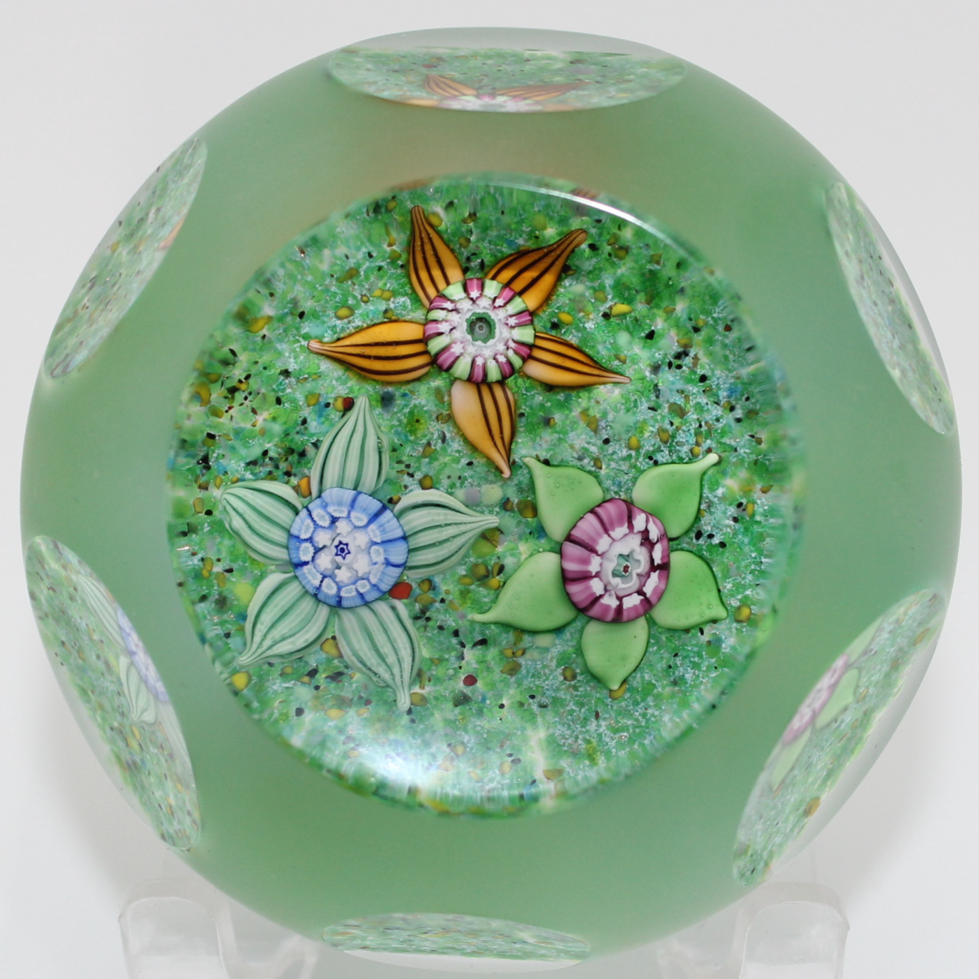 2025  Faceted triflora canes on a green ground by Craig  Deacons.