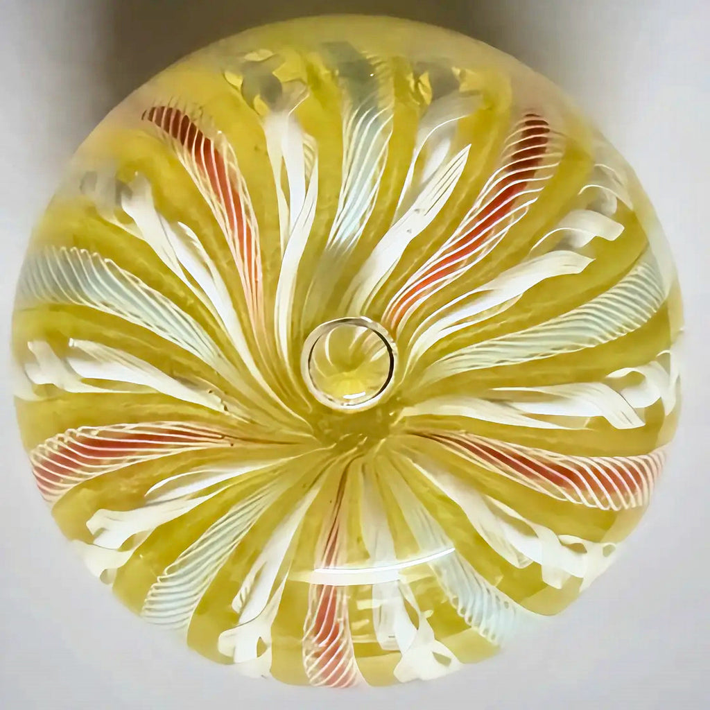 A lovely Yellow crown with alternating latticinio and collored ribbons running from pole to pole. Bubble placed at top middle of crown for a nice effect. 2.75" JD cane in base
