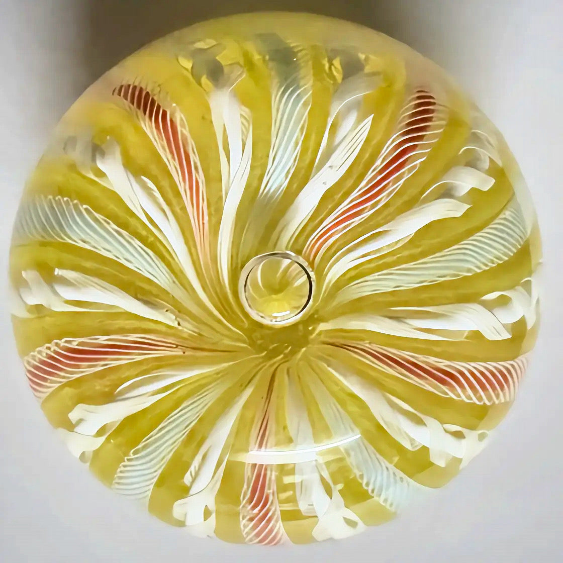 A lovely Yellow crown with alternating latticinio and collored ribbons running from pole to pole. Bubble placed at top middle of crown for a nice effect. 2.75" JD cane in base