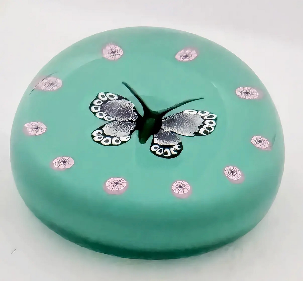 A 2002 William Manson Snr. 1/1 aventurine butterfly on a nice opaque teal ground surrounded by a cane garland. 2.7". Scratch signed on base.