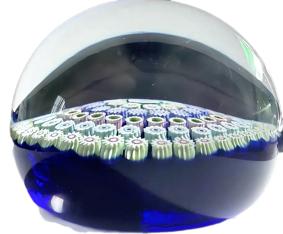 Deacons Glass 5 concentric rows of tight and crisp millefiori surrounding by a center Clichy style rose a top a translucent cobalt ground. Lovely weight. 2.80"